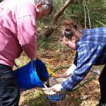 Prof. Mark Horton, and archaeologist Rosie Ireland demonstrating the process of 'flotation.'