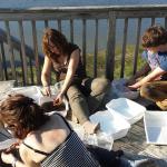 UoB students cleaning the artifacts in the sun....