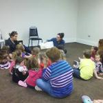 Lead UoB graduate student, Charlie Goudge, and archaeologist Rosie Ireland reading to the local children at the Hatteras Public Library for 'Story Time with the Young Diggers.'