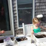 CAS Volunteers, Kirra and Sabra Dawson cleaning artifacts in style on the porch!  